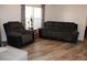 Comfortable living room with neutral walls, laminate flooring, sofa and recliner at 7807 E Main St # G-23, Mesa, AZ 85207