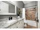 Bathroom features granite countertops, tiled shower with curtain, and a decorative mirror at 7940 E Quill Ln, Scottsdale, AZ 85255