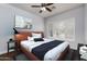 Bedroom features a modern platform bed, shuttered windows, stylish decor and a ceiling fan at 7940 E Quill Ln, Scottsdale, AZ 85255