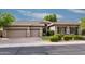 Charming single-Gathering home with a three-car garage, neutral paint, stone accents, and manicured landscaping at 7940 E Quill Ln, Scottsdale, AZ 85255