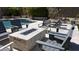 Relaxing outdoor seating area with a stone fire pit, ideal for entertaining and enjoying cozy evenings at 7940 E Quill Ln, Scottsdale, AZ 85255
