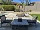 Inviting patio with a fire pit, comfortable seating, and lush greenery, perfect for outdoor gatherings at 7940 E Quill Ln, Scottsdale, AZ 85255