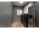 Well-equipped laundry room with modern washer and dryer, ample counter space, and tile flooring at 7940 E Quill Ln, Scottsdale, AZ 85255