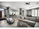 Spacious living room with open floor plan and kitchen views, featuring neutral tones and modern furnishings at 7940 E Quill Ln, Scottsdale, AZ 85255