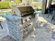 Well-equipped stainless steel outdoor grill with granite countertop, stone base, and convenient storage at 7940 E Quill Ln, Scottsdale, AZ 85255