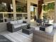 Covered patio area with comfortable seating, dining set, ceiling fan, and stylish rug at 7940 E Quill Ln, Scottsdale, AZ 85255