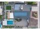 This aerial view reveals a solar-paneled roof, lush backyard with pool and a small grass yard at 8037 E Krail St, Scottsdale, AZ 85250