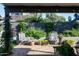 Covered back patio featuring brick flooring, patio seating and views of the lush backyard landscaping at 8037 E Krail St, Scottsdale, AZ 85250
