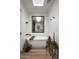 Bright bathroom features a soaking tub, wood accents, a decorative mirror, and stylish decor with plants at 8037 E Krail St, Scottsdale, AZ 85250