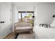 Bedroom nook features a stylish settee and a large window with bright light and outdoor view at 8037 E Krail St, Scottsdale, AZ 85250