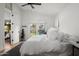 Bedroom with an open door to the backyard featuring a view of the pool, a comfortable bed, and minimalist decor at 8037 E Krail St, Scottsdale, AZ 85250