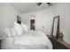 Comfortable bedroom featuring plush pillows, minimalist decor, and a large mirror, creating a relaxing atmosphere at 8037 E Krail St, Scottsdale, AZ 85250