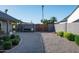 Gravel driveway with metal gate leading to the charming home at 8037 E Krail St, Scottsdale, AZ 85250
