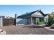 Exterior view of the home with drought tolerant landscaping, brick walkway and privacy gate at 8037 E Krail St, Scottsdale, AZ 85250