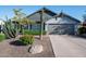 Home exterior featuring desert landscaping, a well-maintained lawn and attached two-car garage at 8037 E Krail St, Scottsdale, AZ 85250