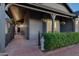 Inviting covered front porch features a brick walkway, potted plants, and charming statue, leading to the front door at 8037 E Krail St, Scottsdale, AZ 85250