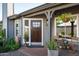 Charming front porch with wood door, stylish planters and seating at 8037 E Krail St, Scottsdale, AZ 85250
