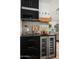 Kitchen nook with a wine fridge, dark countertops, gold hardware and decor at 8037 E Krail St, Scottsdale, AZ 85250