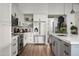 Well-equipped kitchen with stainless steel appliances, white cabinetry, a spacious island, and modern fixtures at 8037 E Krail St, Scottsdale, AZ 85250