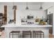 Modern kitchen featuring a spacious island, white cabinets, stainless steel appliances, and stylish pendant lighting at 8037 E Krail St, Scottsdale, AZ 85250