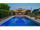 Luxurious pool with modern lighting, featuring an outdoor seating area under a covered patio at 8037 E Krail St, Scottsdale, AZ 85250