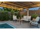 Cozy poolside lounge area featuring comfortable seating and shaded space under a stylish pergola with string lights at 8037 E Krail St, Scottsdale, AZ 85250