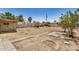 Backyard featuring a fire pit, sparse landscaping, and access to alley at 8101 E 4Th Ave, Mesa, AZ 85208