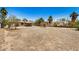 A large backyard with a view of the back of the house, trailer, and trees at 8101 E 4Th Ave, Mesa, AZ 85208