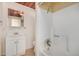 A bathroom with a mirror, toilet, bathtub and shower at 8101 E 4Th Ave, Mesa, AZ 85208