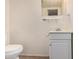 Bathroom featuring a toilet, vanity and mirror in a neutral color palette, providing a clean, functional space at 8101 E 4Th Ave, Mesa, AZ 85208