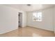 A bedroom with tile flooring, a window with blinds, and an open door to the bathroom at 8101 E 4Th Ave, Mesa, AZ 85208