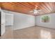 Spacious bedroom with a unique wood ceiling, tile flooring, and a ceiling fan for added comfort at 8101 E 4Th Ave, Mesa, AZ 85208