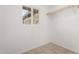 Bright walk-in closet featuring tiled floors, a window for natural light, and a simple storage shelf with hanging space at 8124 N 45Th Ave, Glendale, AZ 85302