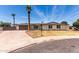 Charming single-story home with a well-maintained lawn, mature palm trees, and a spacious driveway at 8124 N 45Th Ave, Glendale, AZ 85302