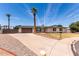 Inviting single-story home with a spacious driveway, palm trees, and manicured front lawn at 8124 N 45Th Ave, Glendale, AZ 85302