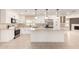 Modern white kitchen boasts stainless steel appliances and granite countertops with breakfast bar at 8124 N 45Th Ave, Glendale, AZ 85302