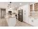 Updated kitchen with white cabinetry, stainless appliances, and granite countertops for modern appeal at 8124 N 45Th Ave, Glendale, AZ 85302