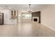 Spacious open-plan living room featuring a brick fireplace, tiled flooring, and a modern kitchen setup at 8124 N 45Th Ave, Glendale, AZ 85302