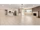 Bright open-concept living space with tile floors, a fireplace, and a modern kitchen in the background at 8124 N 45Th Ave, Glendale, AZ 85302