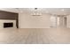 Spacious living room with tile floors and modern light fixture, and a classic white-brick fireplace at 8124 N 45Th Ave, Glendale, AZ 85302