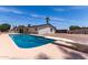 Backyard swimming pool featuring a diving board, surrounded by concrete decking and gravel landscaping, perfect for outdoor fun at 8124 N 45Th Ave, Glendale, AZ 85302