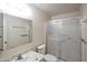 Bright bathroom with a shower, toilet, vanity, and frosted glass shower doors at 8326 E Valley View Rd, Scottsdale, AZ 85250