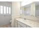 Cozy bathroom with a sink, marble countertop, window with shutters, and tiled floors at 8326 E Valley View Rd, Scottsdale, AZ 85250