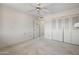 Bedroom showing an attached closet with double doors and ceiling fan at 8326 E Valley View Rd, Scottsdale, AZ 85250