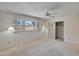 Spacious bedroom features neutral carpet, ceiling fan, and ample closet space at 8326 E Valley View Rd, Scottsdale, AZ 85250