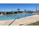 Large community pool with lane markers, lounge chairs, and shade structures for residents' enjoyment at 8326 E Valley View Rd, Scottsdale, AZ 85250