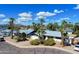 Charming single-Gathering home with palm trees and a well-maintained front yard under a blue sky at 8326 E Valley View Rd, Scottsdale, AZ 85250