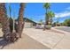 Charming home with a spacious driveway, two-car garage, and mature palm trees at 8326 E Valley View Rd, Scottsdale, AZ 85250