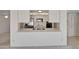 An open kitchen featuring white cabinets, bar seating, and stainless steel appliances at 8326 E Valley View Rd, Scottsdale, AZ 85250