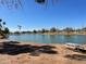 Serene lake view with lush green surroundings and a picnic table, perfect for outdoor recreation at 8326 E Valley View Rd, Scottsdale, AZ 85250